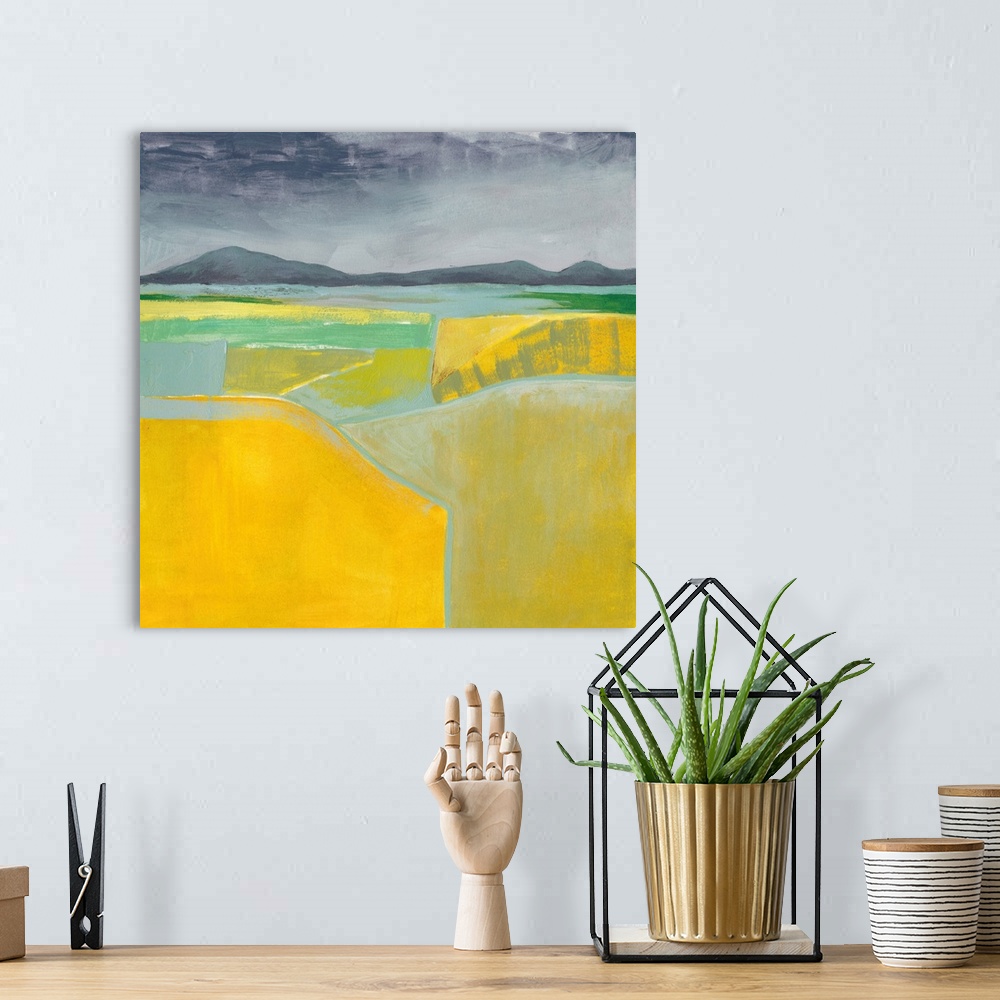 A bohemian room featuring Abstract landscape painting using vibrant yellow in the foreground of the image.