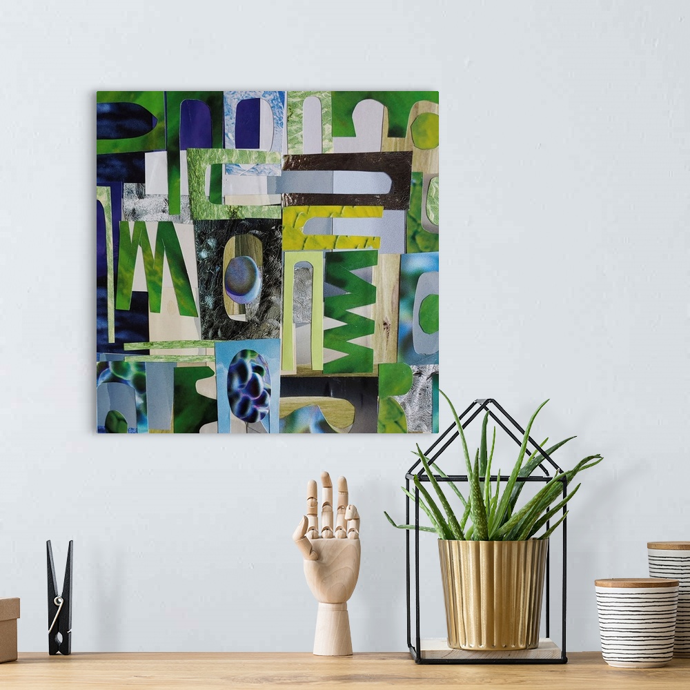 A bohemian room featuring A mixed media piece featuring cut out paper shapes in shades of blue, green and grey