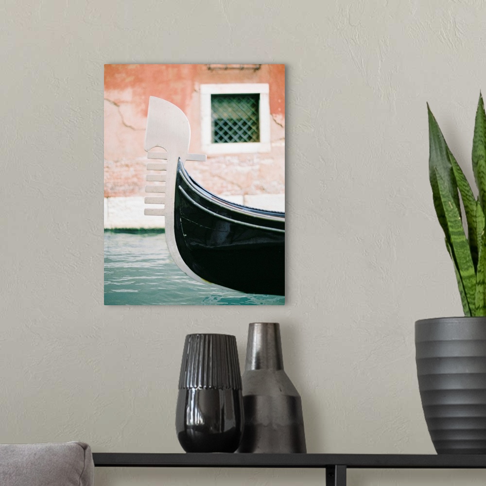 A modern room featuring Photograph of the decoration on the end of a gondola on a canal in Venice, Italy.