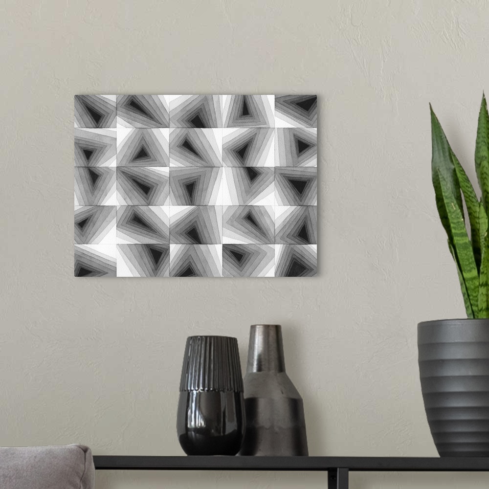 A modern room featuring Contemporary abstract artwork of a grid of geometric shapes in gradating gray tones.