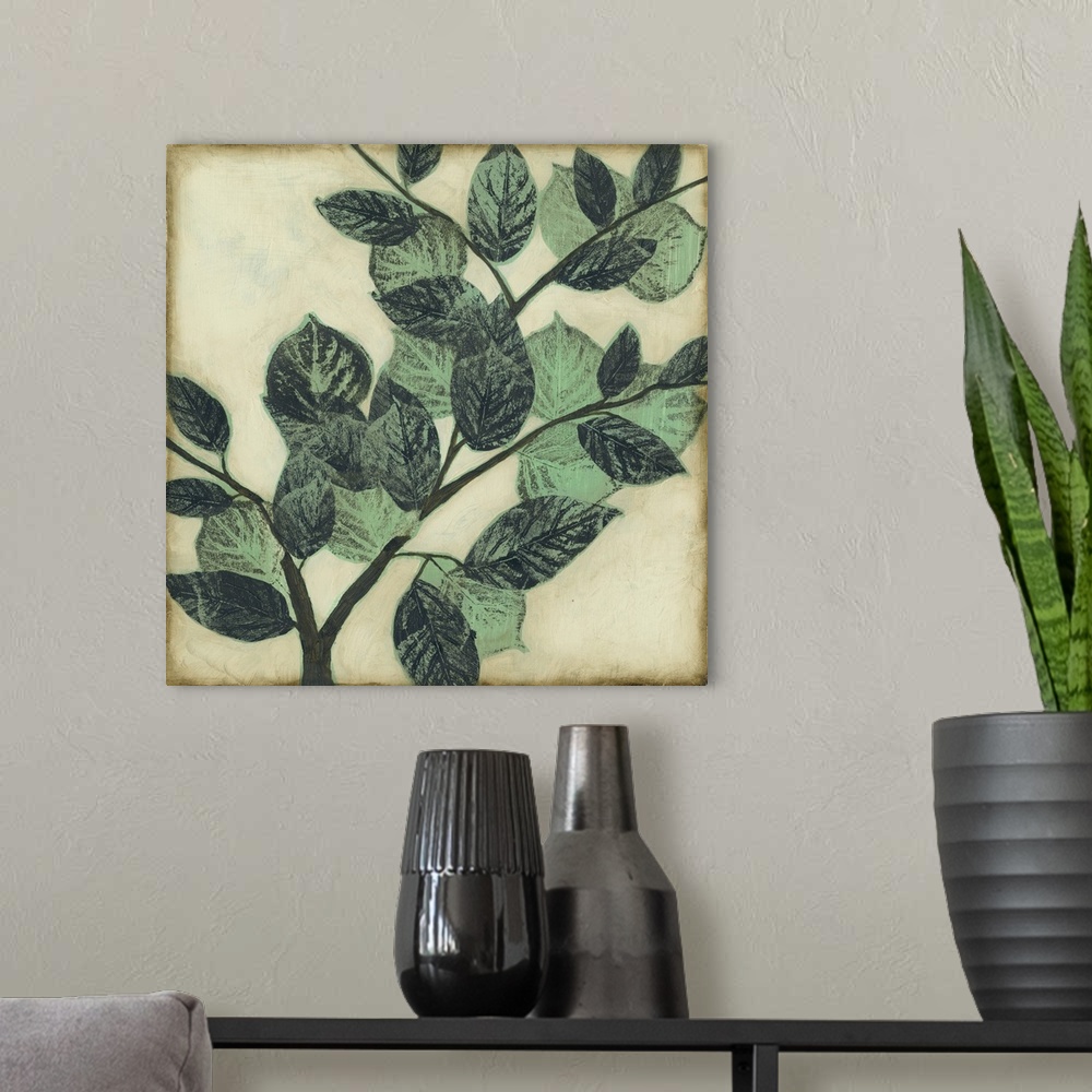A modern room featuring Home decor artwork of muted green leaves on a twig against a light pale green background.