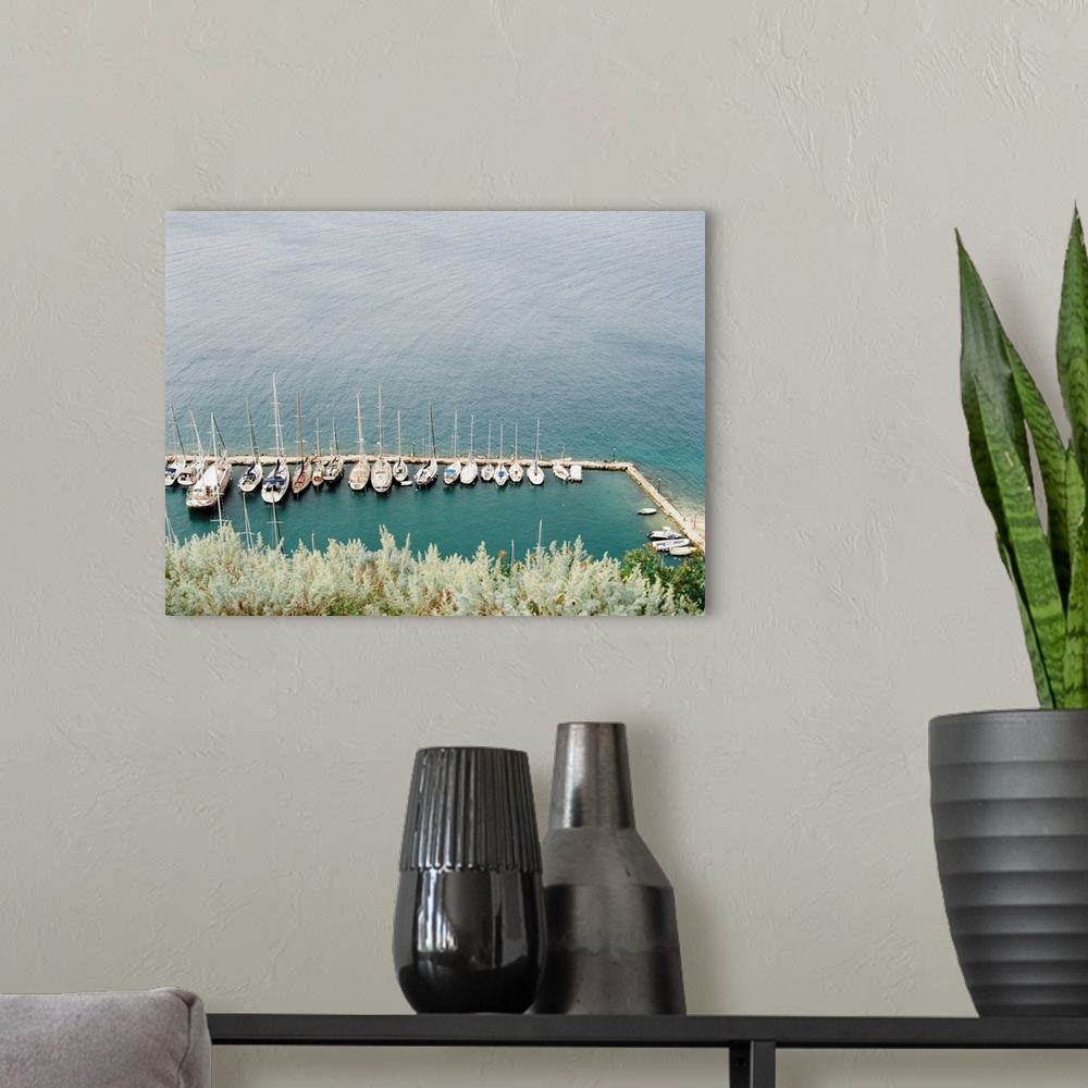 A modern room featuring Photograph of several sailing boats moored in a simple marina, Corfu, Greece.