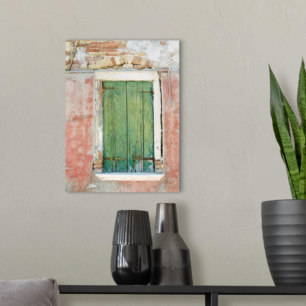 A modern room featuring Photograph of a small window with ancient green shutters, Burano, Italy.