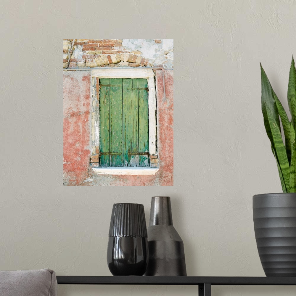 A modern room featuring Photograph of a small window with ancient green shutters, Burano, Italy.