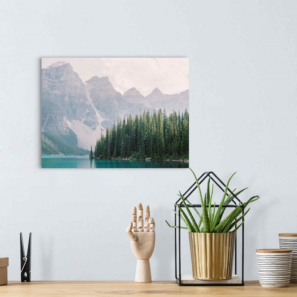 A bohemian room featuring Photograph of tall evergreen trees at the edge of a clear blue lake, Moraine Lake, Banff national...