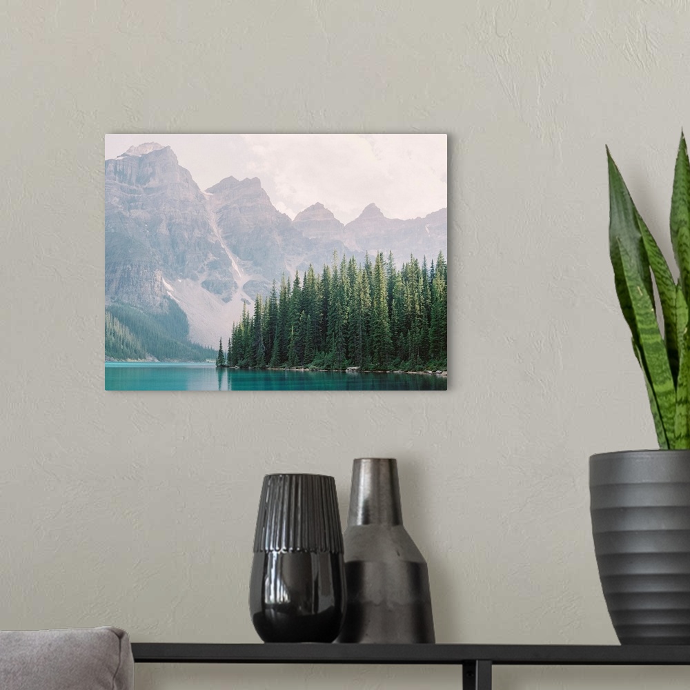 A modern room featuring Photograph of tall evergreen trees at the edge of a clear blue lake, Moraine Lake, Banff national...
