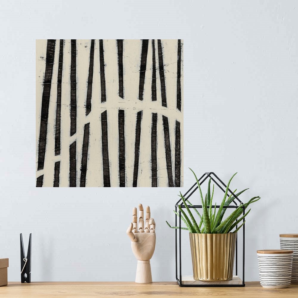 A bohemian room featuring Black and white abstract artwork made of parallel lines.