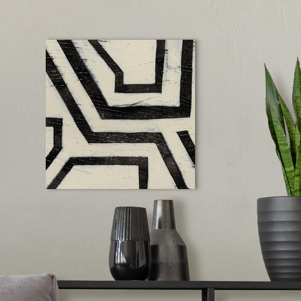 A modern room featuring Black and white abstract artwork made of angled lines.