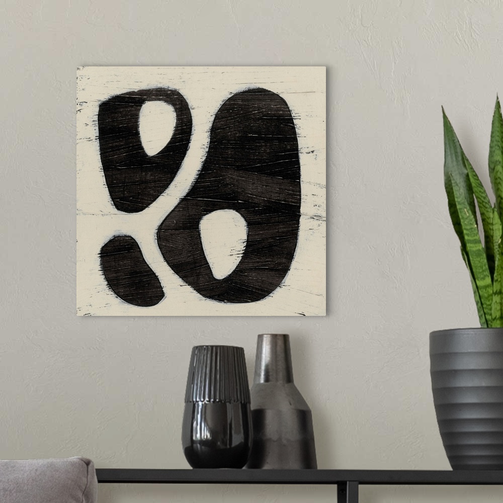 A modern room featuring Black and white abstract artwork made of round shapes.