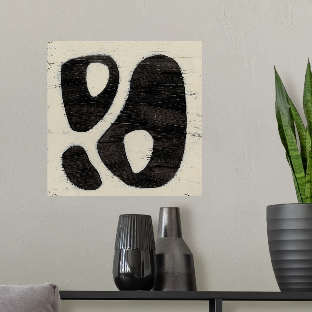 A modern room featuring Black and white abstract artwork made of round shapes.