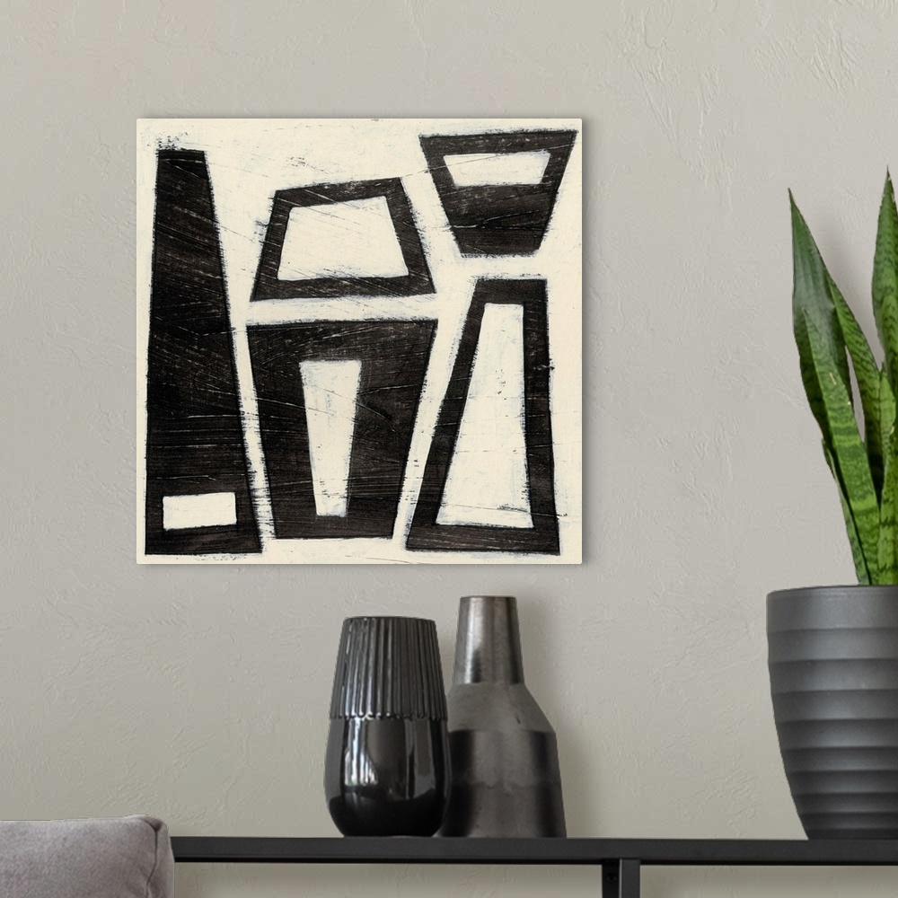 A modern room featuring Black and white abstract artwork made of trapezoids.