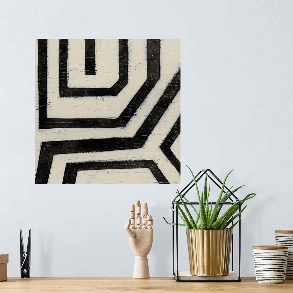 A bohemian room featuring Black and white abstract artwork made of angled lines.