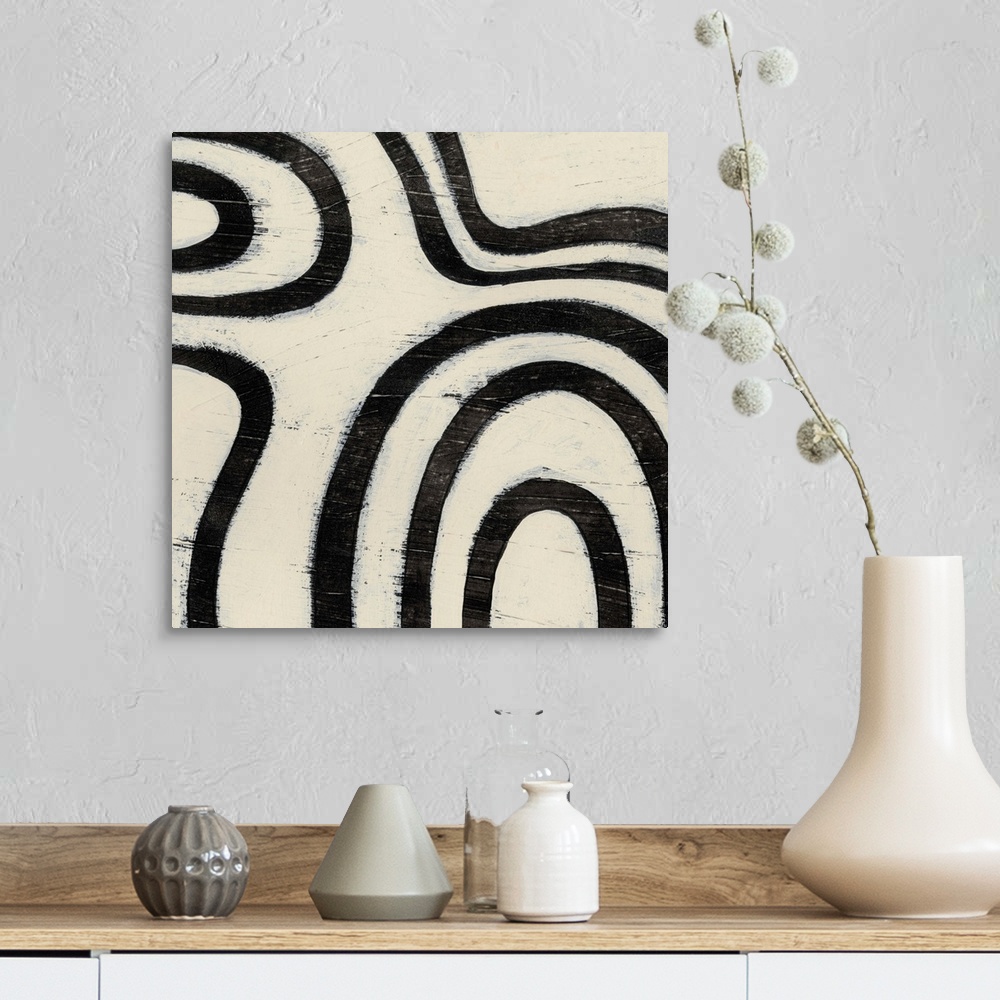 A farmhouse room featuring Black and white abstract artwork made of curved lines.