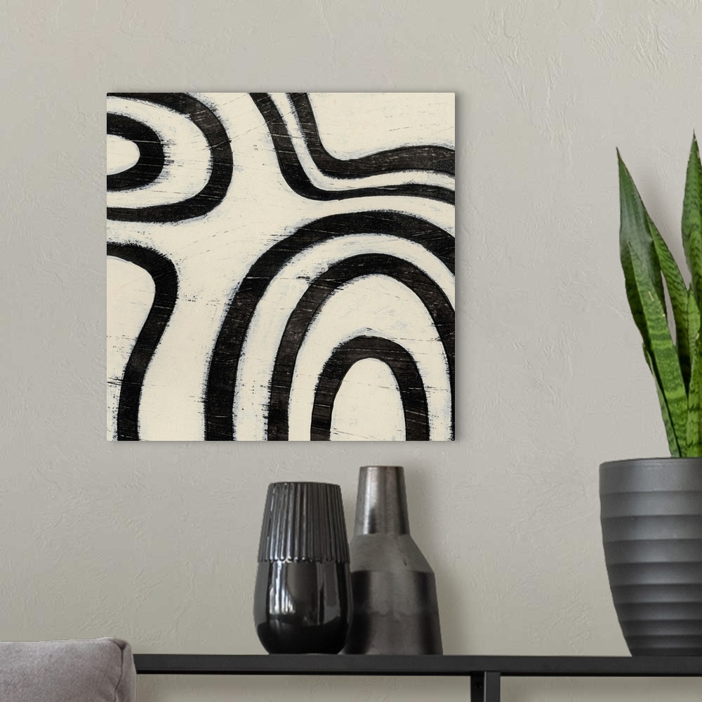A modern room featuring Black and white abstract artwork made of curved lines.