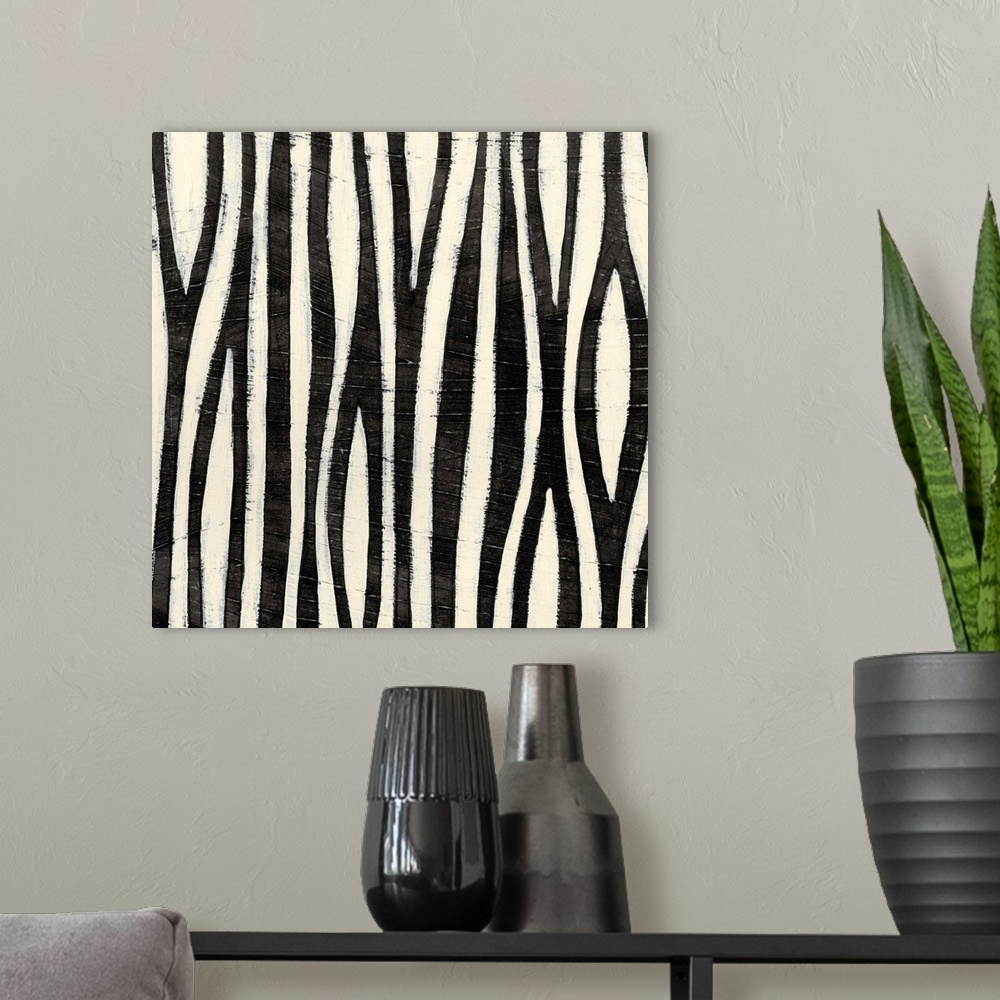 A modern room featuring Black and white abstract artwork made of vertical stripes.