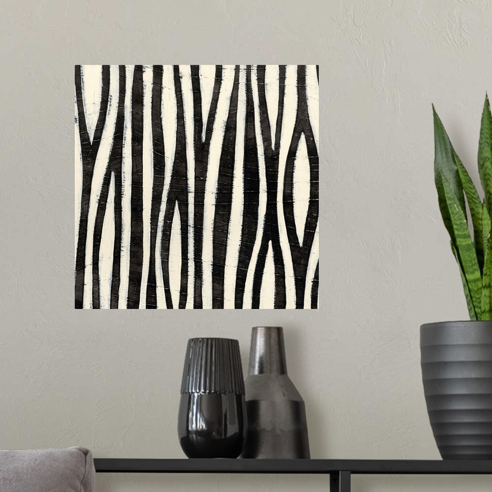 A modern room featuring Black and white abstract artwork made of vertical stripes.