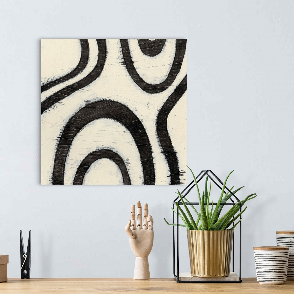 A bohemian room featuring Black and white abstract artwork made of curved lines.
