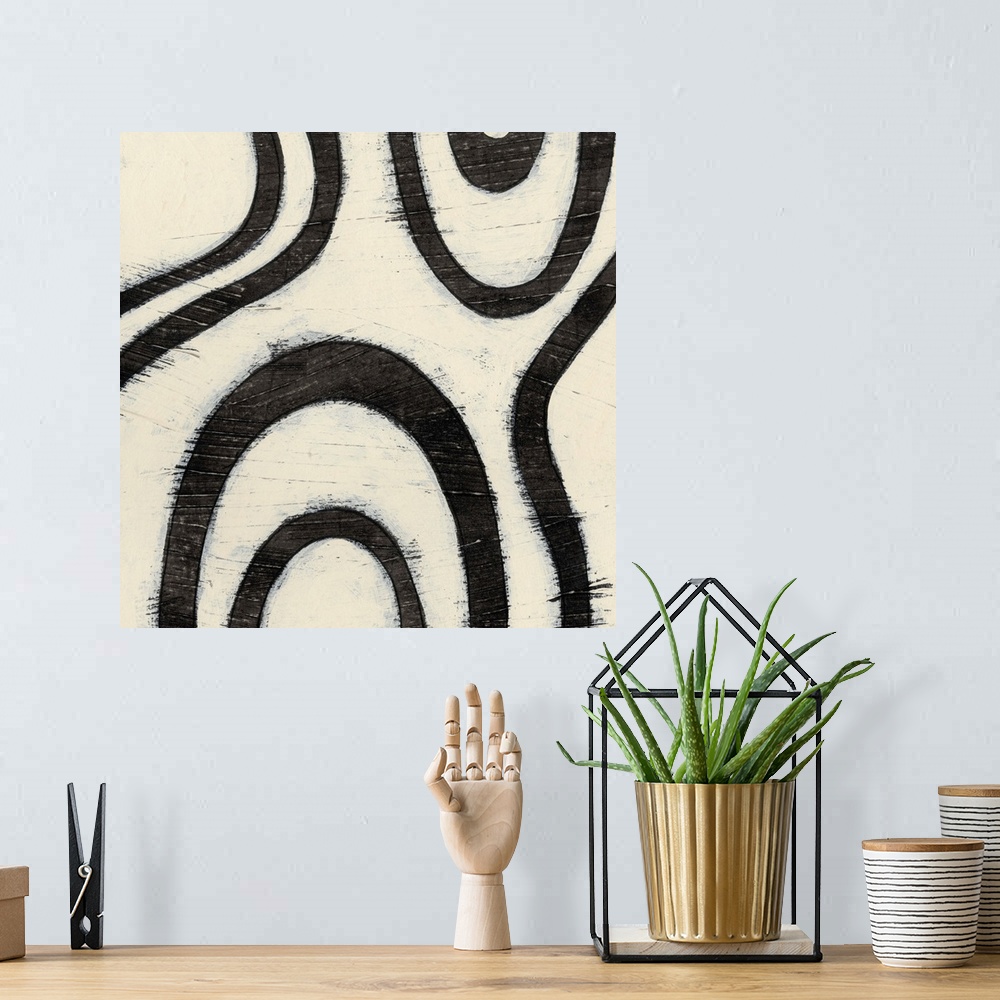 A bohemian room featuring Black and white abstract artwork made of curved lines.
