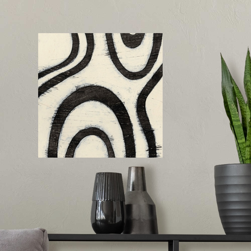A modern room featuring Black and white abstract artwork made of curved lines.