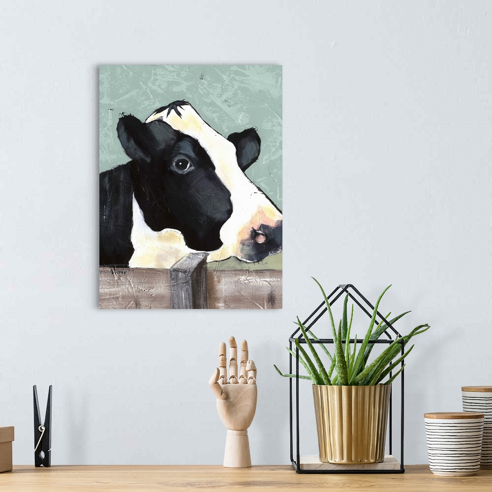 A bohemian room featuring Contemporary portrait of a black and white dairy cow with a sweet expression.
