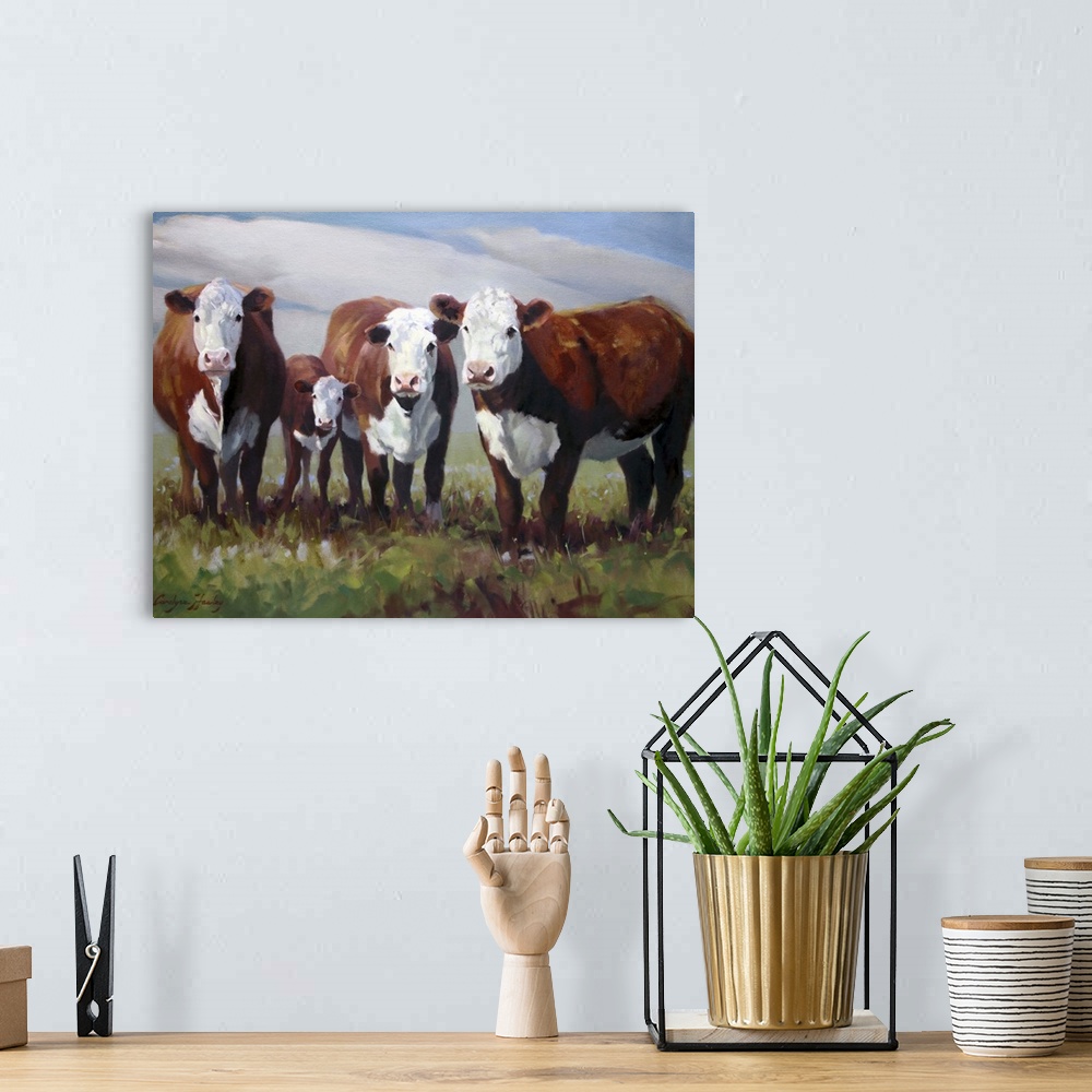 A bohemian room featuring Contemporary painting of a family of cows in a field.