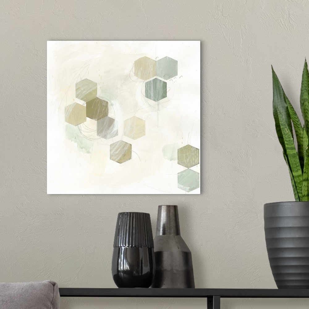 A modern room featuring Pale earth tone colored artwork of hexagonal shapes.