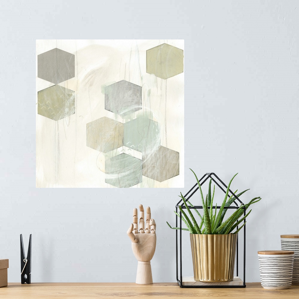 A bohemian room featuring Pale earth tone colored artwork of hexagonal shapes.