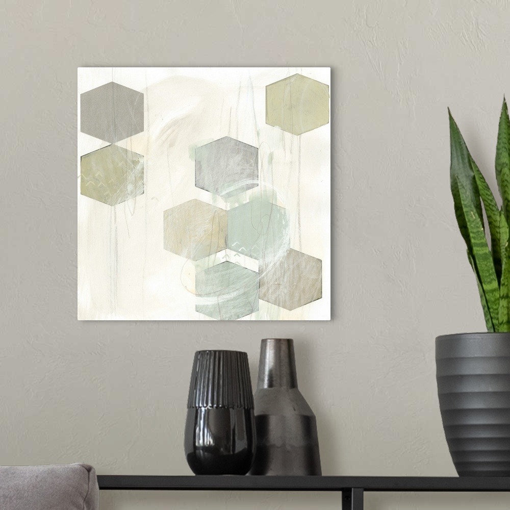 A modern room featuring Pale earth tone colored artwork of hexagonal shapes.