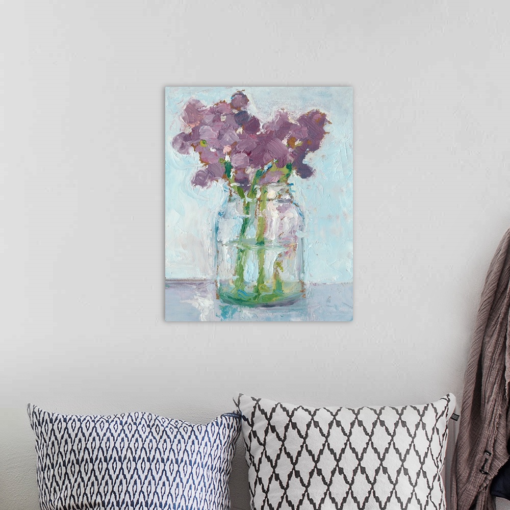 A bohemian room featuring Impressionist style art print of purple flowers in a glass vase.