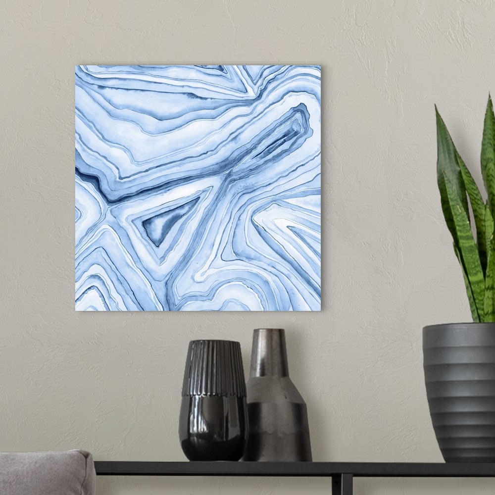 A modern room featuring Contemporary watercolor painting of light and dark blue layers of paint to resemble agate.