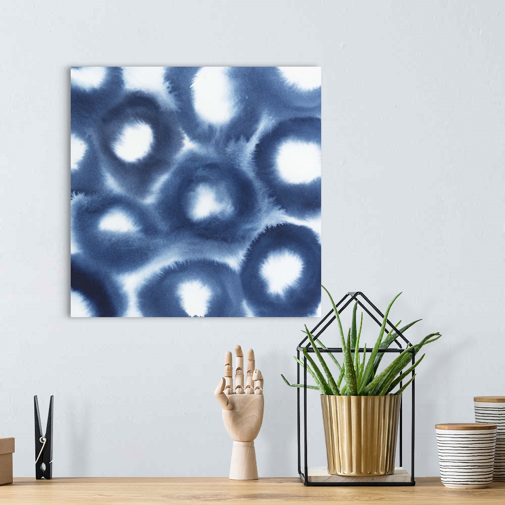 A bohemian room featuring Contemporary artwork of faded deep blue patterns made with a water based ink that bleeds when app...