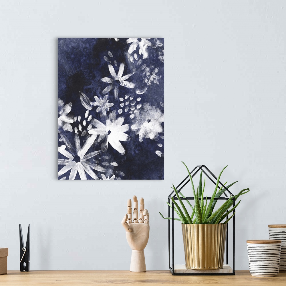 A bohemian room featuring Contemporary artwork of white silhouetted flowers against a dark blue background.