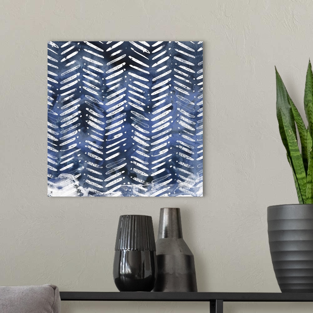 A modern room featuring Shibori style artwork in white and indigo of classic pattern motifs.