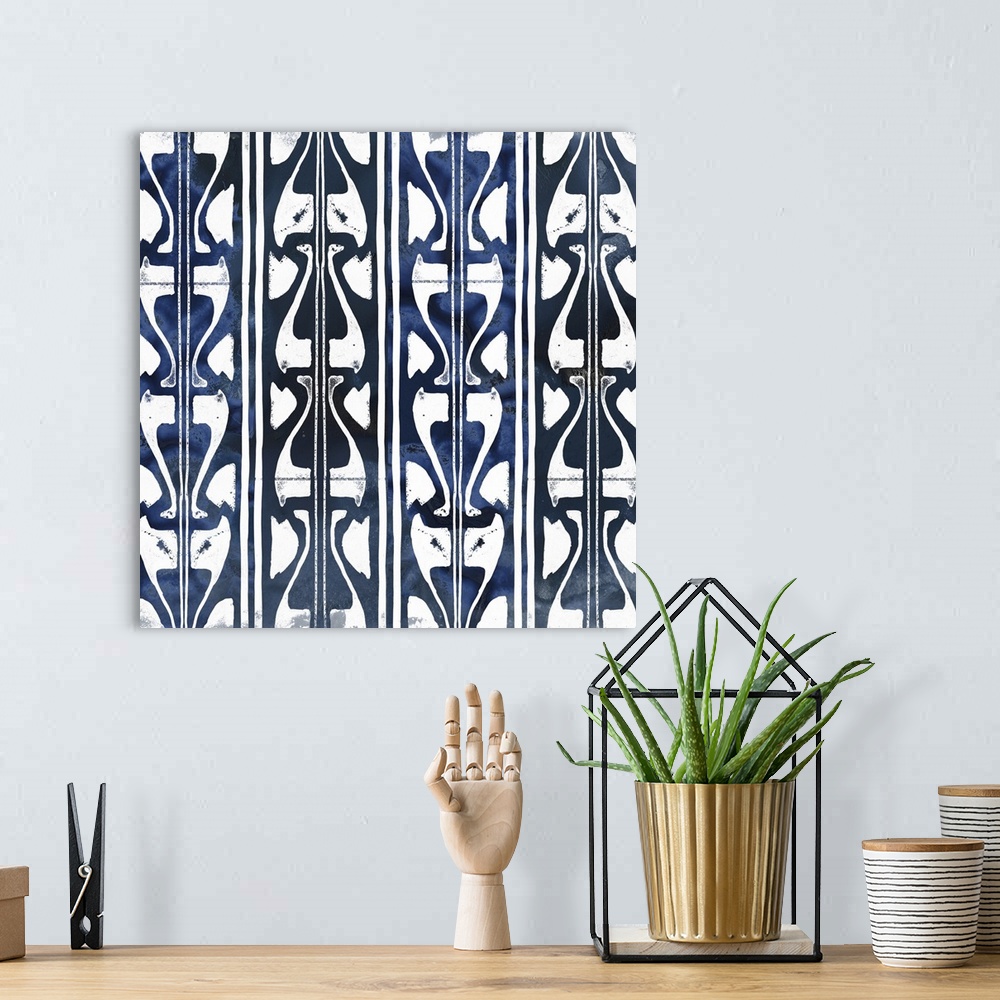 A bohemian room featuring Shibori style artwork in white and indigo of classic pattern motifs.