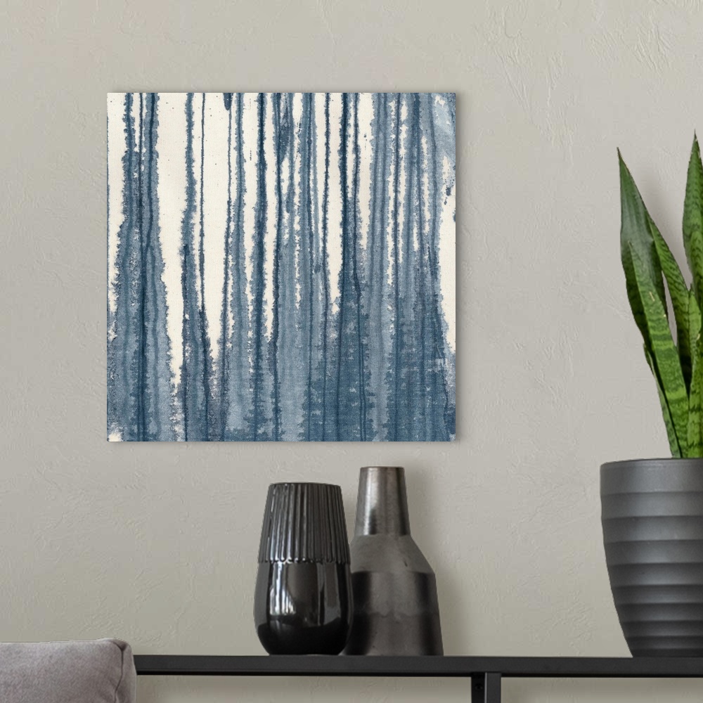 A modern room featuring A contemporary painting of blending vertical lines of indigo blue on a cream background.