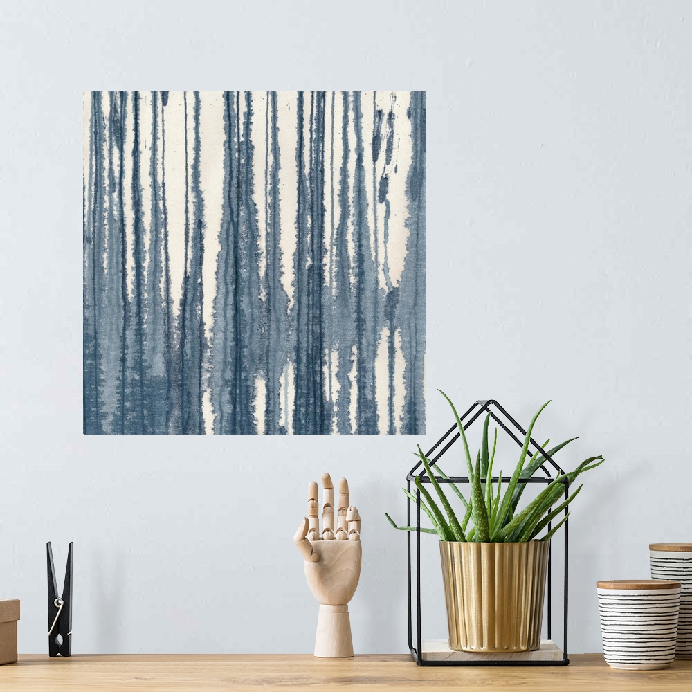 A bohemian room featuring A contemporary painting of blending vertical lines of indigo blue on a cream background.