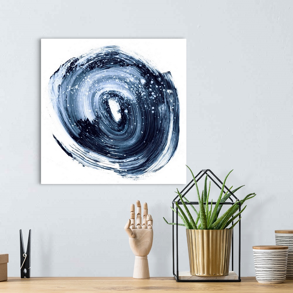 A bohemian room featuring Contemporary abstract painting of a circular nebula shape in a dark indigo blue against a white b...