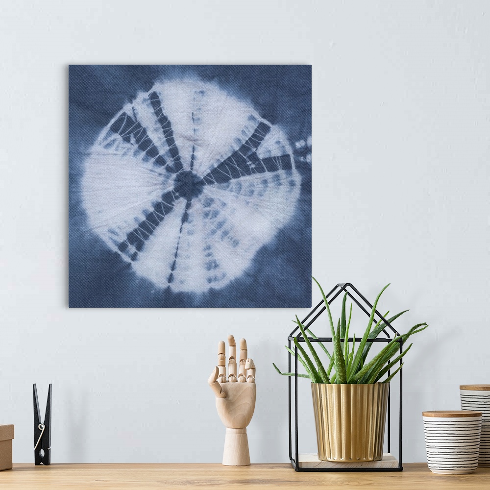 A bohemian room featuring Artistic design of a large tie-dye circle in white on a blue background.