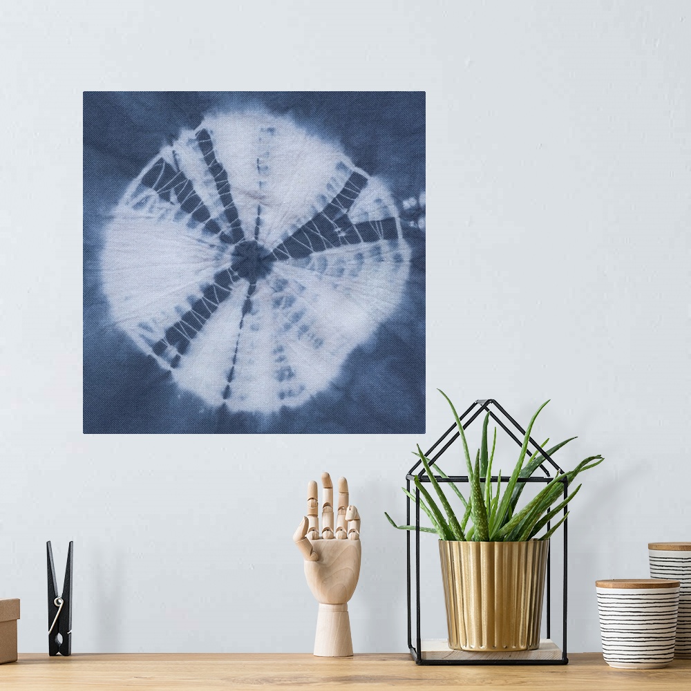 A bohemian room featuring Artistic design of a large tie-dye circle in white on a blue background.