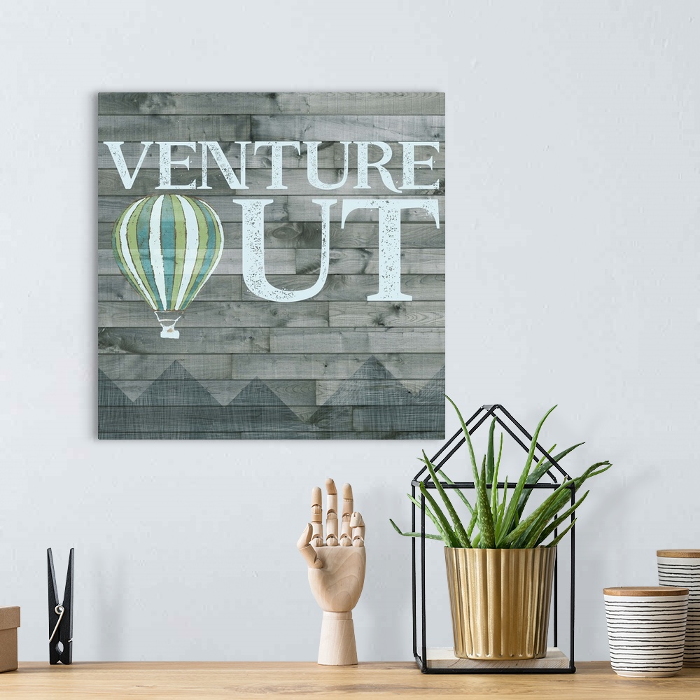 A bohemian room featuring Inspirational decorative artwork of the phrase "Venture Out" with a hot air balloon design.