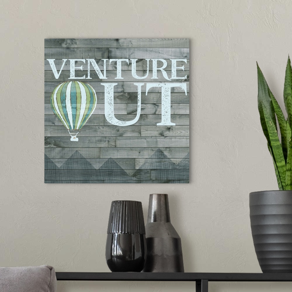 A modern room featuring Inspirational decorative artwork of the phrase "Venture Out" with a hot air balloon design.
