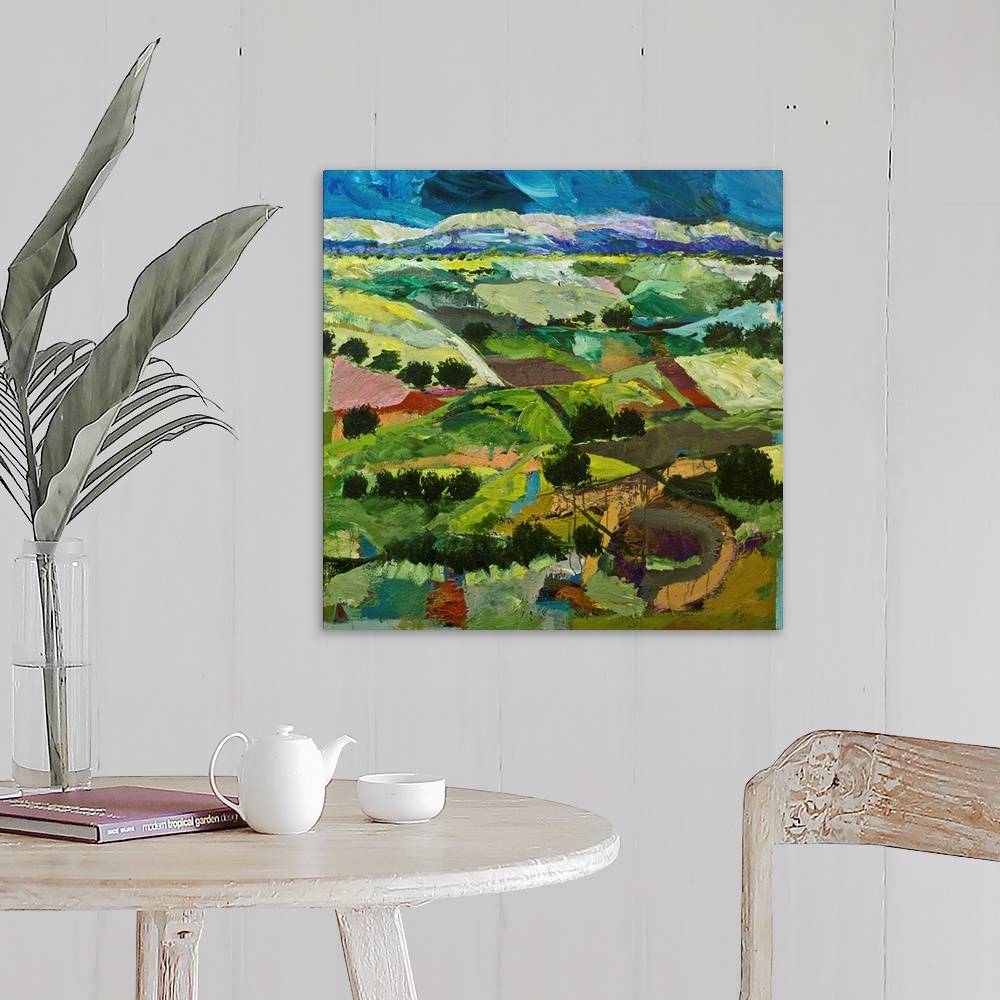 A farmhouse room featuring Contemporary painting of a country landscape with many tilled fields lined with trees.