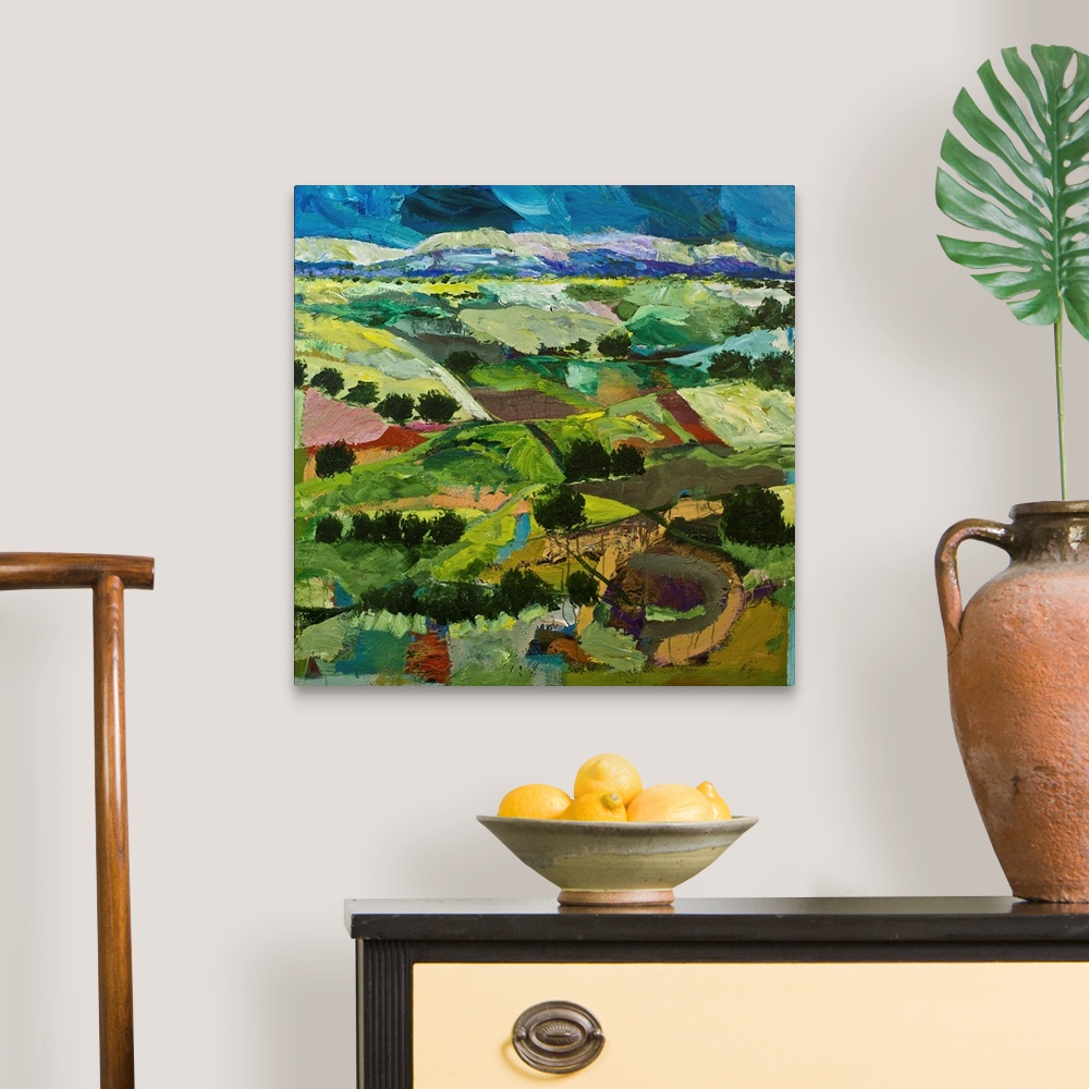 A traditional room featuring Contemporary painting of a country landscape with many tilled fields lined with trees.