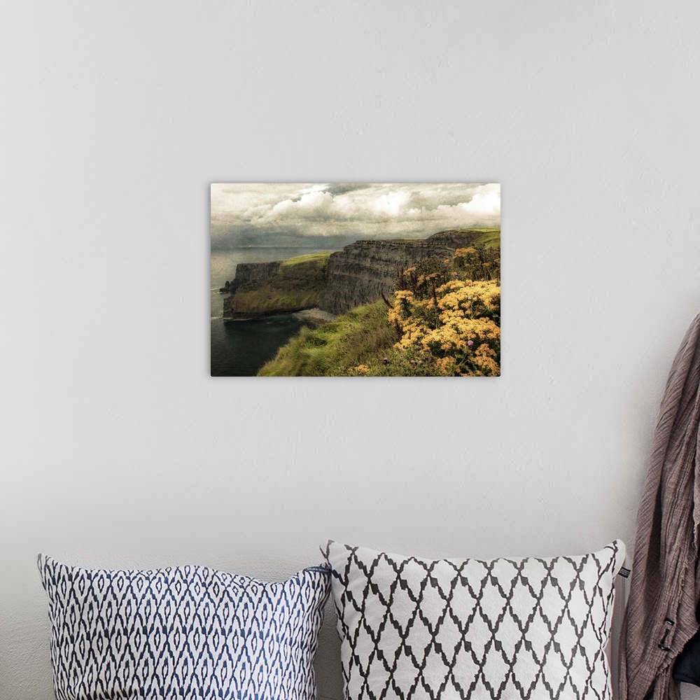 A bohemian room featuring Fine art photo of cliffs on the Irish coast under a cloudy sky.