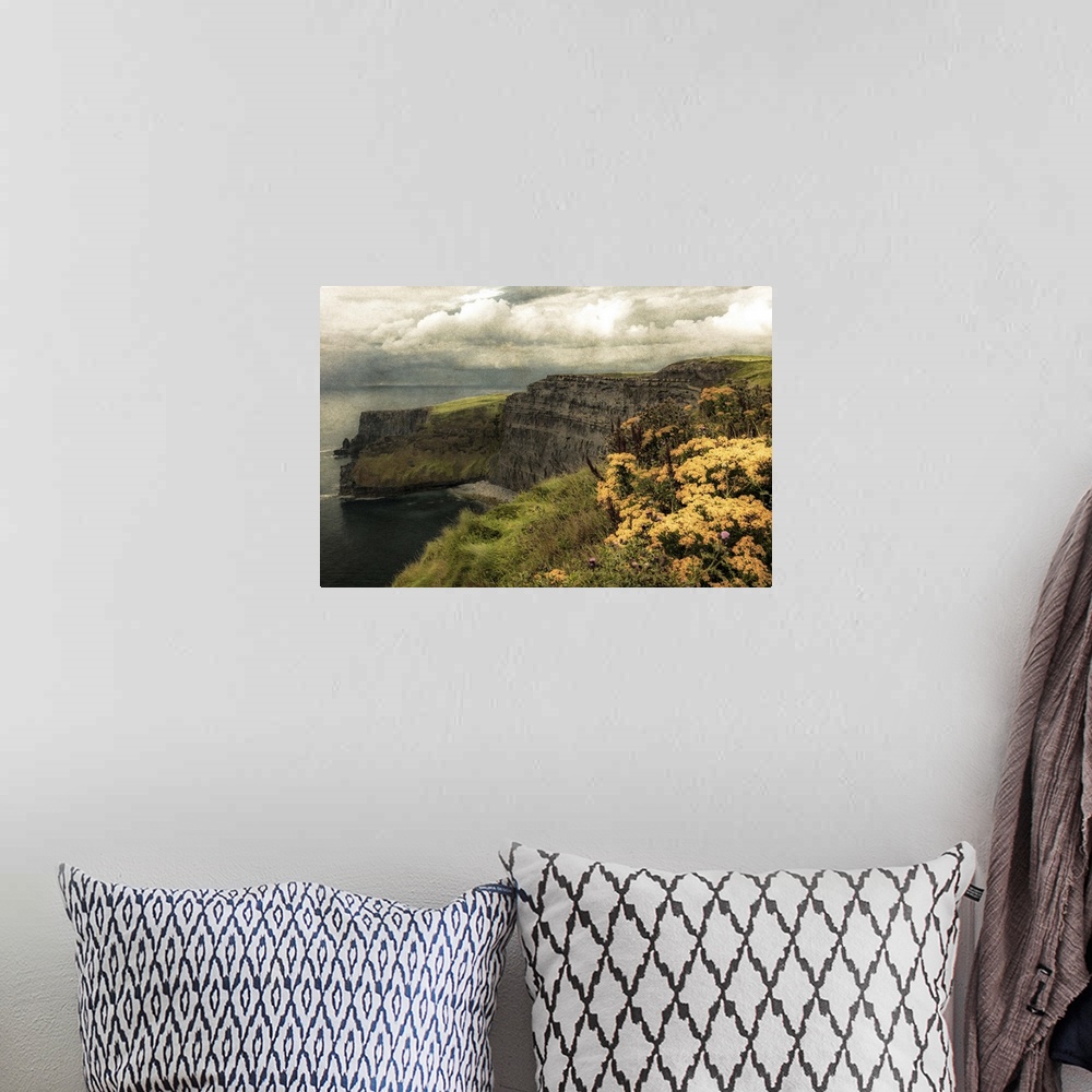 A bohemian room featuring Fine art photo of cliffs on the Irish coast under a cloudy sky.