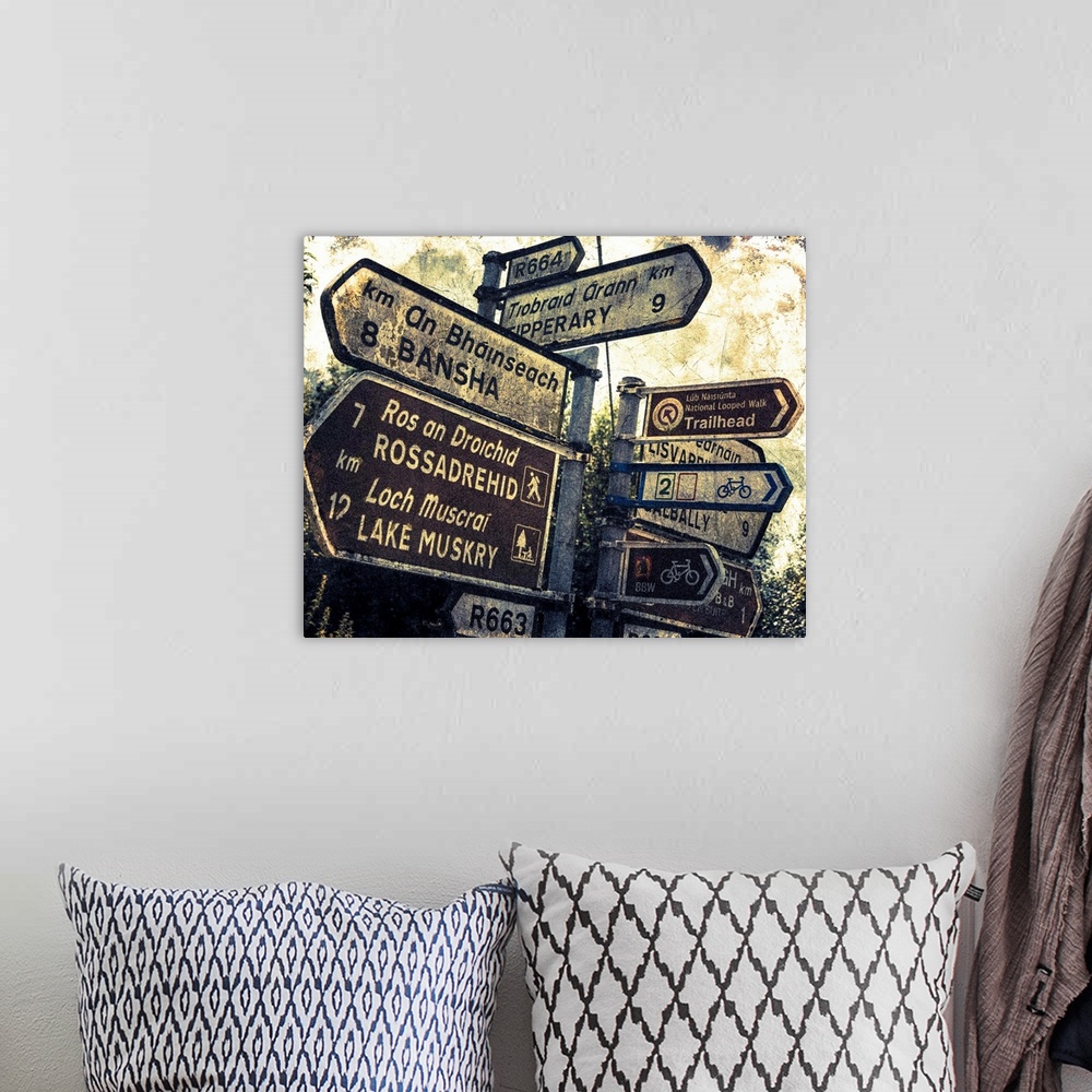 A bohemian room featuring Fine art photo of a signpost in Ireland with several directional signs, with a grunge effect.