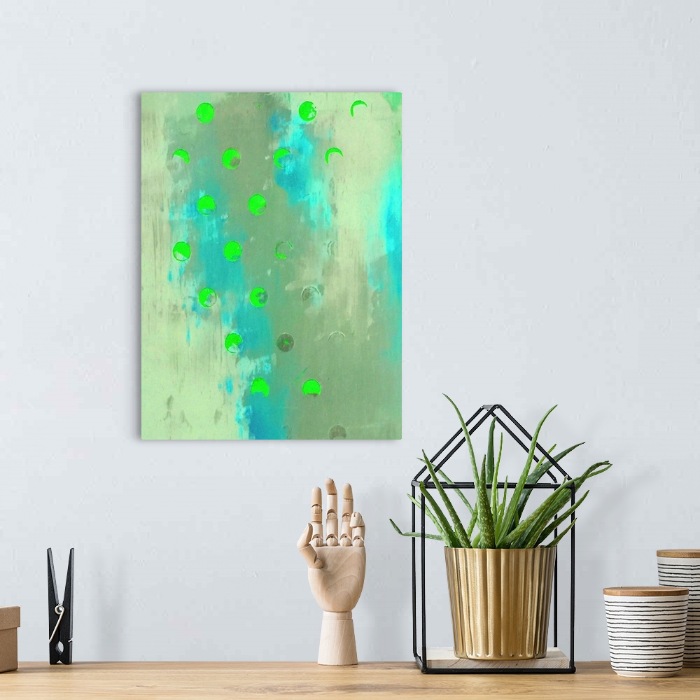 A bohemian room featuring A vertical abstract painting of shades of blue and green with neon green circles overlapping.