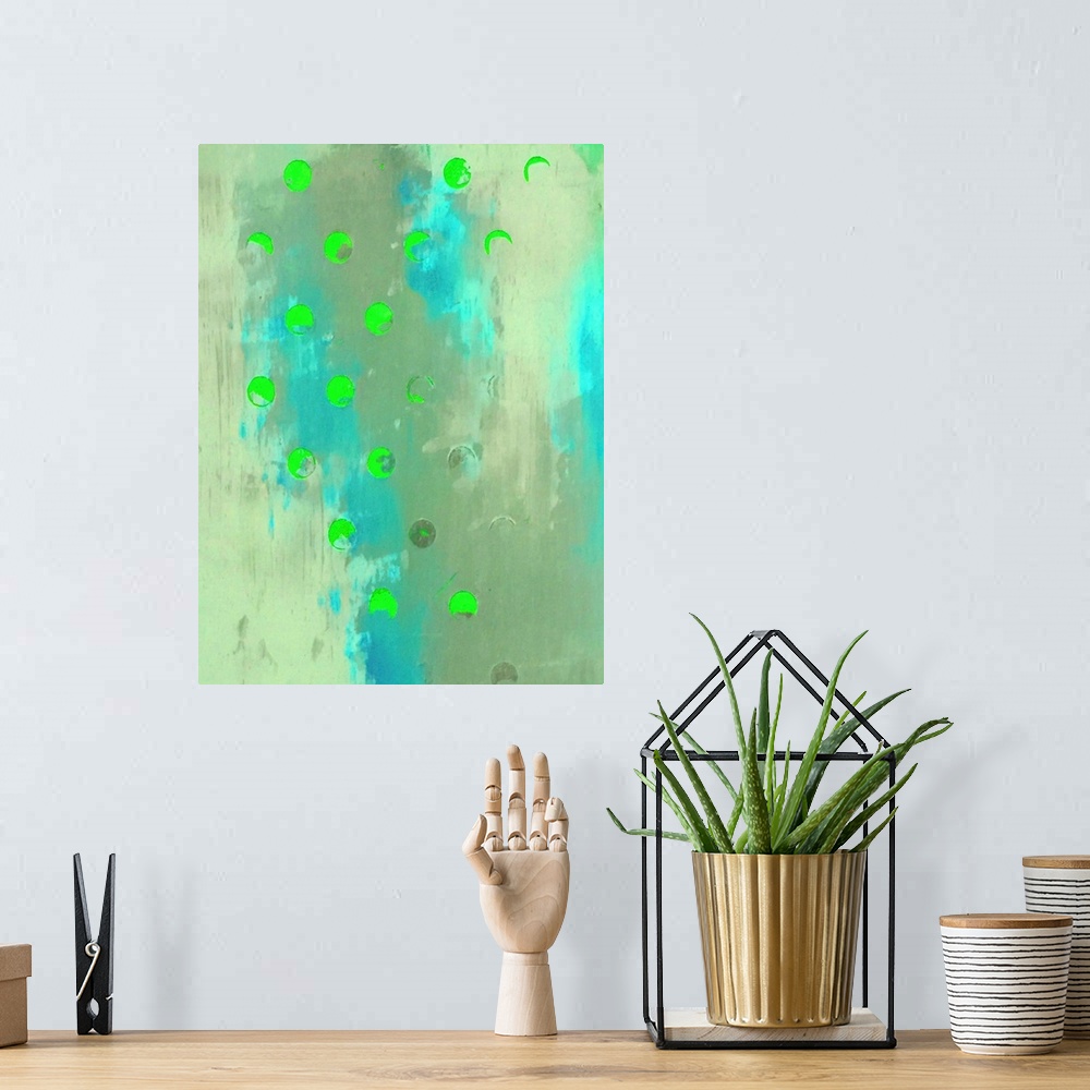 A bohemian room featuring A vertical abstract painting of shades of blue and green with neon green circles overlapping.
