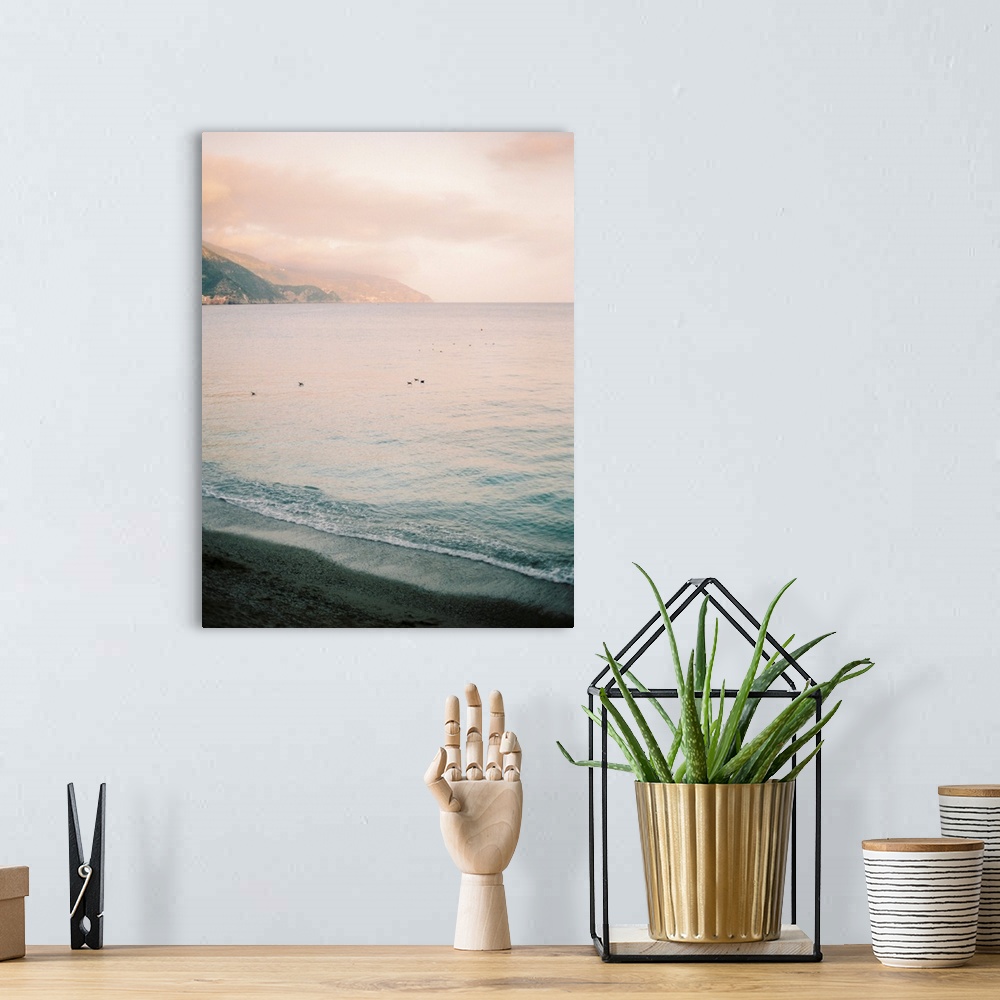 A bohemian room featuring A serene photograph of waves lapping the shore at sunset.