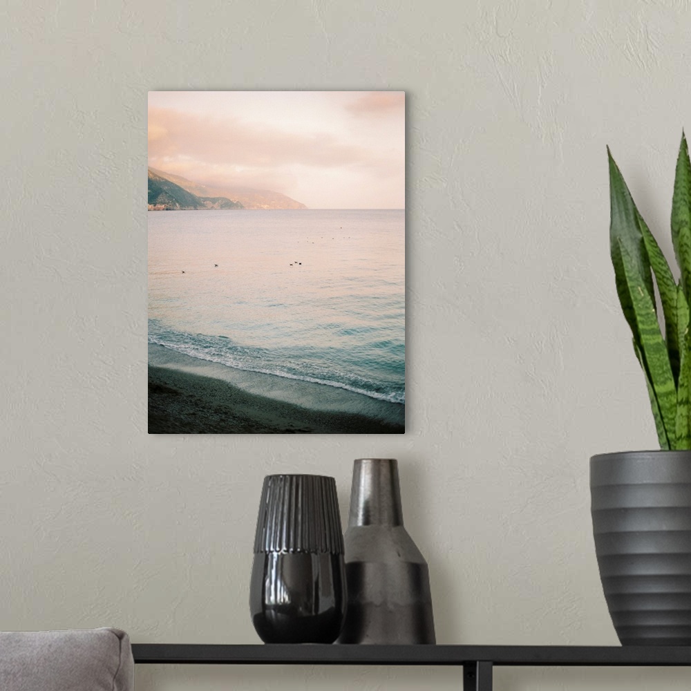 A modern room featuring A serene photograph of waves lapping the shore at sunset.